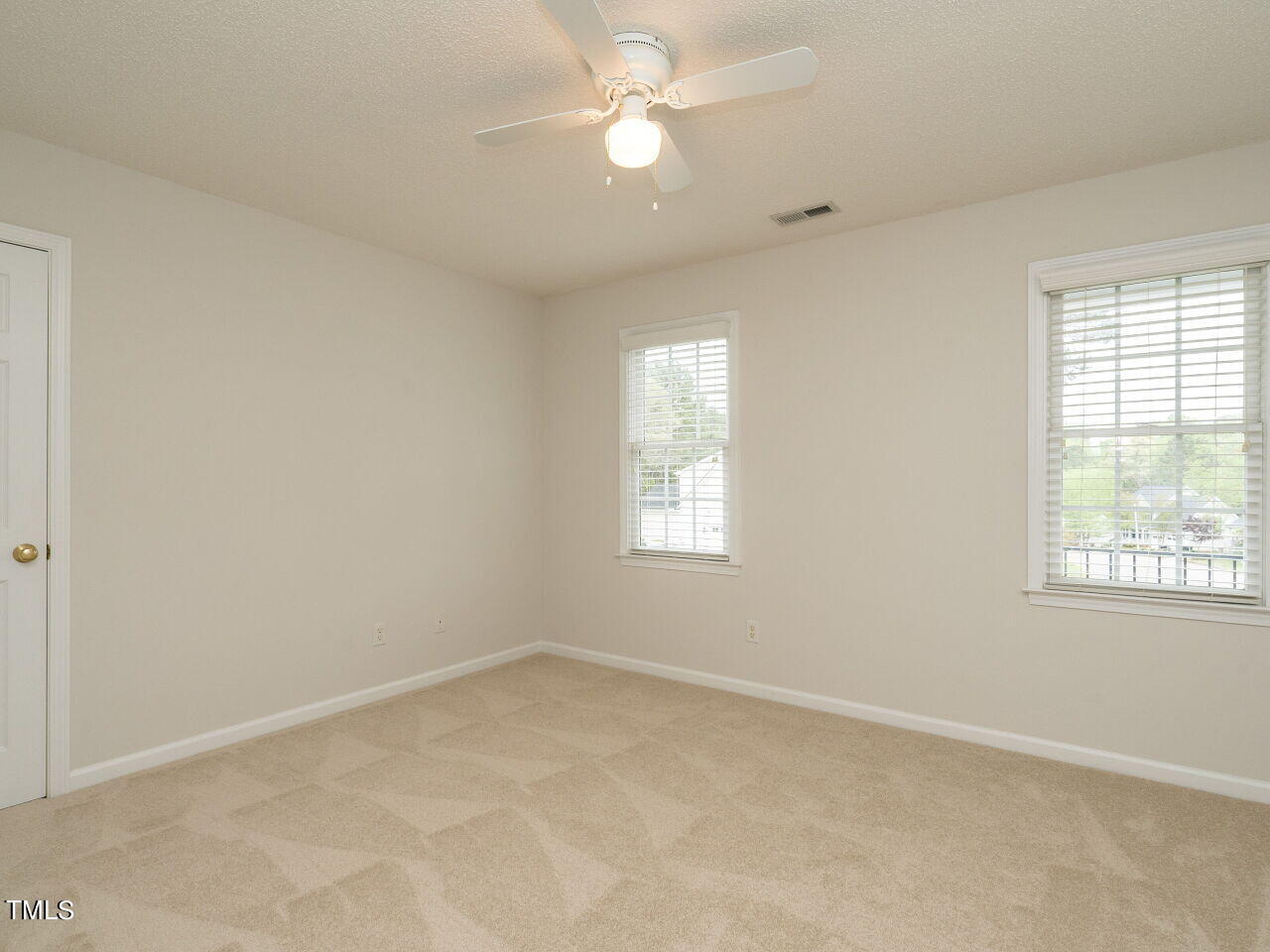 760 Hadrian Drive Garner, NC 27529 - Photo 25 of 38 an empty room with a window and ceiling fan