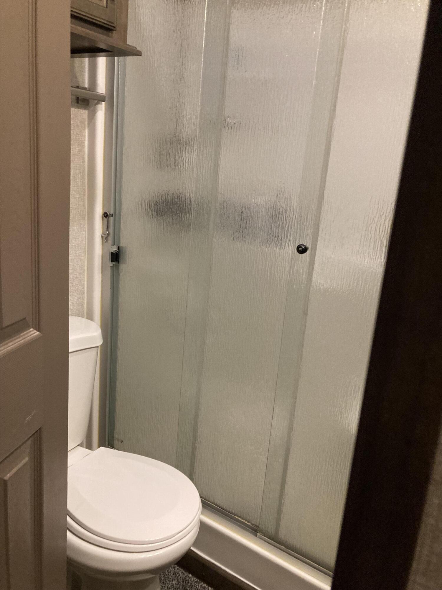 69411 Ramon Road, Unit 21 Cathedral City, CA 92234 - Photo 7 of 9 a white toilet sitting next to a shower