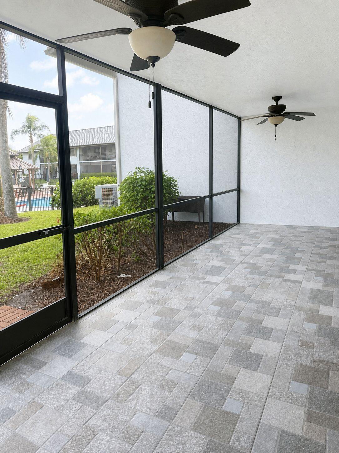 1871 Southwest Palm City Road, Unit G401 Stuart, FL 34994 - Photo 13 of 16 a view of a room with a window and ceiling fan