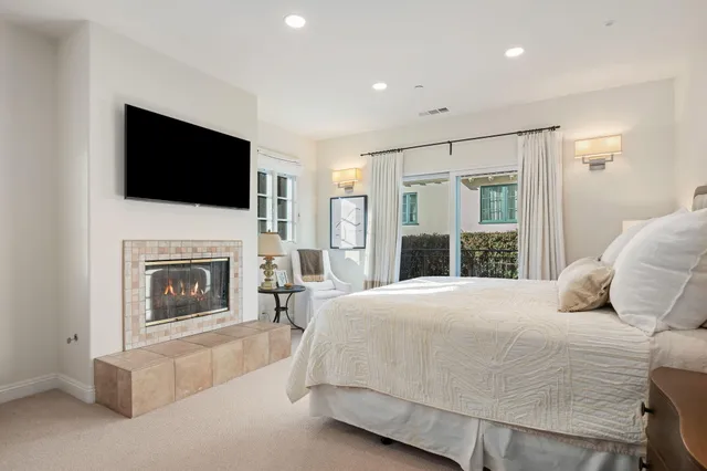 a bedroom with a bed and a fireplace