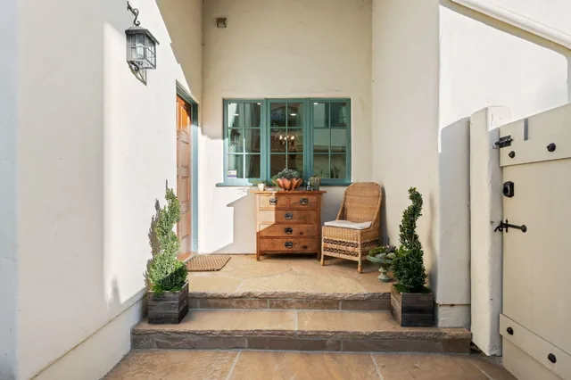 a living room with furniture and large windows