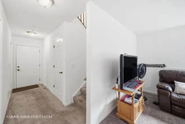 a view of a workspace with furniture and a window
