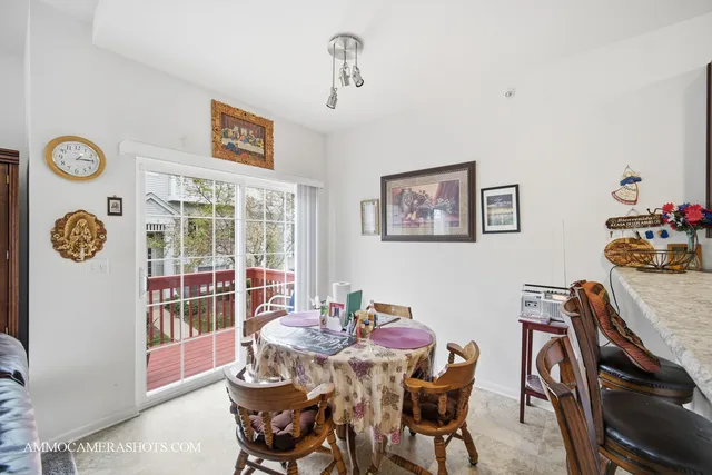 a dining room with furniture and a window