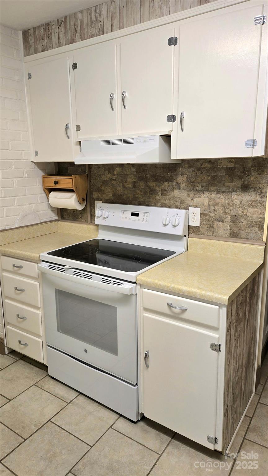 1294 Cane Creek Road Bakersville, NC 28705 - Photo 13 of 43 a kitchen with granite countertop white cabinets and white appliances