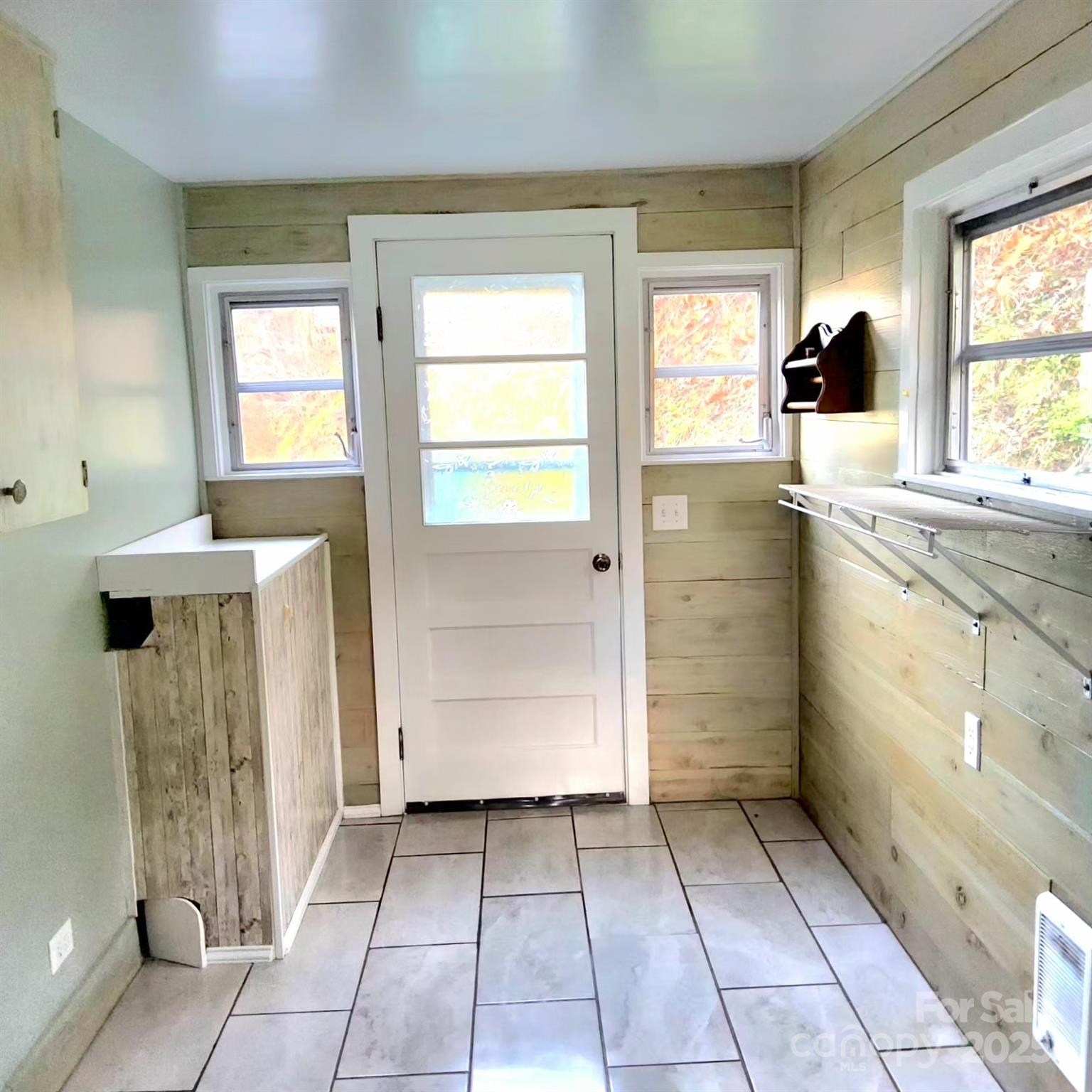 1294 Cane Creek Road Bakersville, NC 28705 - Photo 16 of 43 a bathroom with a sink a toilet and large mirror