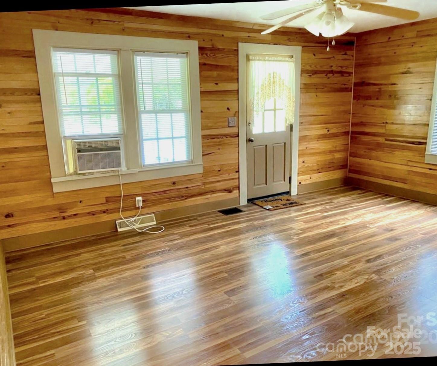 1294 Cane Creek Road Bakersville, NC 28705 - Photo 9 of 43 en empty room with wooden floor and windows