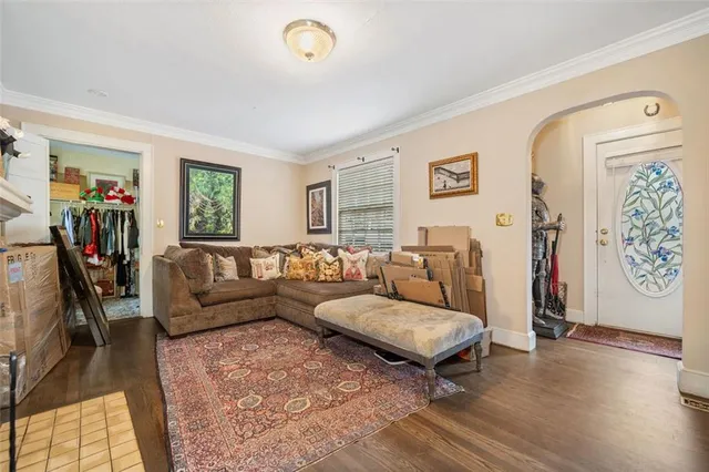 a living room with furniture fireplace and a large window