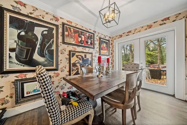 a kitchen with stainless steel appliances white cabinets a stove a sink and a large window