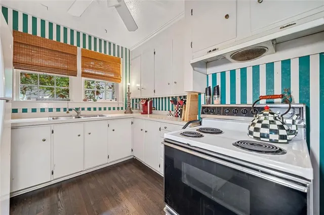a kitchen with cabinets appliances and a sink