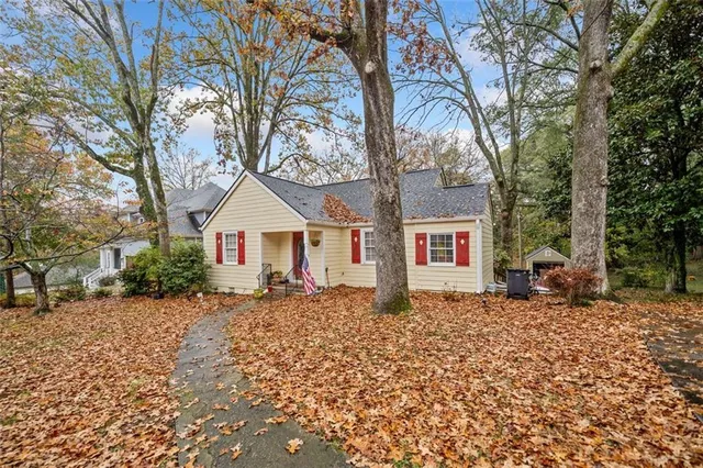 a wooden house with trees in front of it