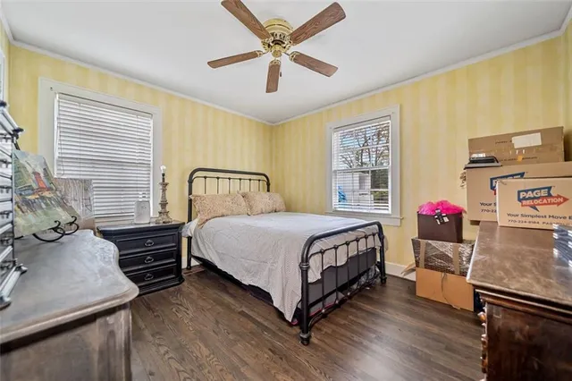 a view of a house with a wooden deck and a trees