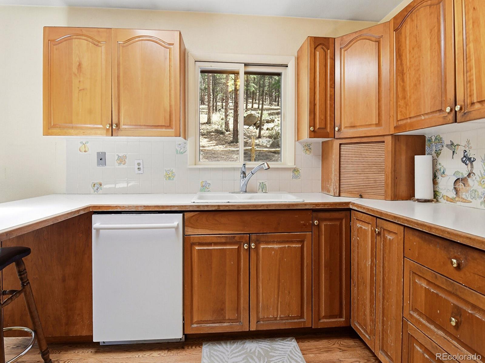 2830 Kerr Gulch Road Evergreen, CO 80439 - Photo 20 of 48 a kitchen with stainless steel appliances granite countertop a sink and a cabinets