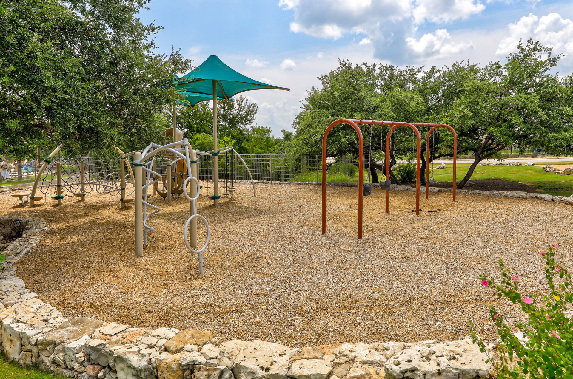 173 Santa Maria Street Georgetown, TX 78628 - Photo 37 of 39 Community playground featuring a multi-structure play system with a shade canopy and a separate swing set