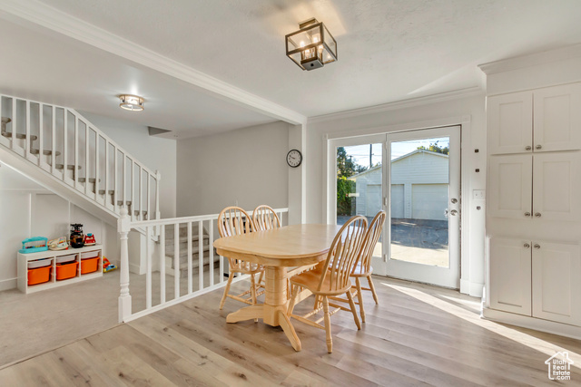 360 East Center Street Centerville, UT 84014 - Photo 14 of 41 Dining room with light wood finished floors, crown molding, and stairs