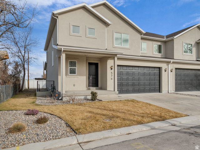 578 West 7th Midvale, UT 84047 - Photo 1 of 35 Traditional-style house with covered porch, a garage, stucco siding, and driveway