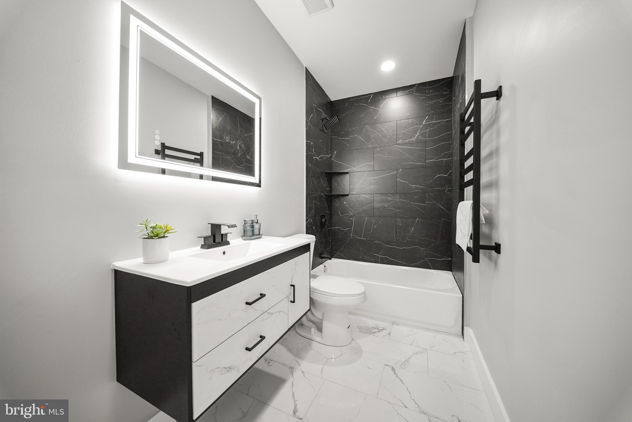 2811 Salmon Street Philadelphia, PA 19134 - Photo 19 of 25 a bathroom with a sink a toilet and shower