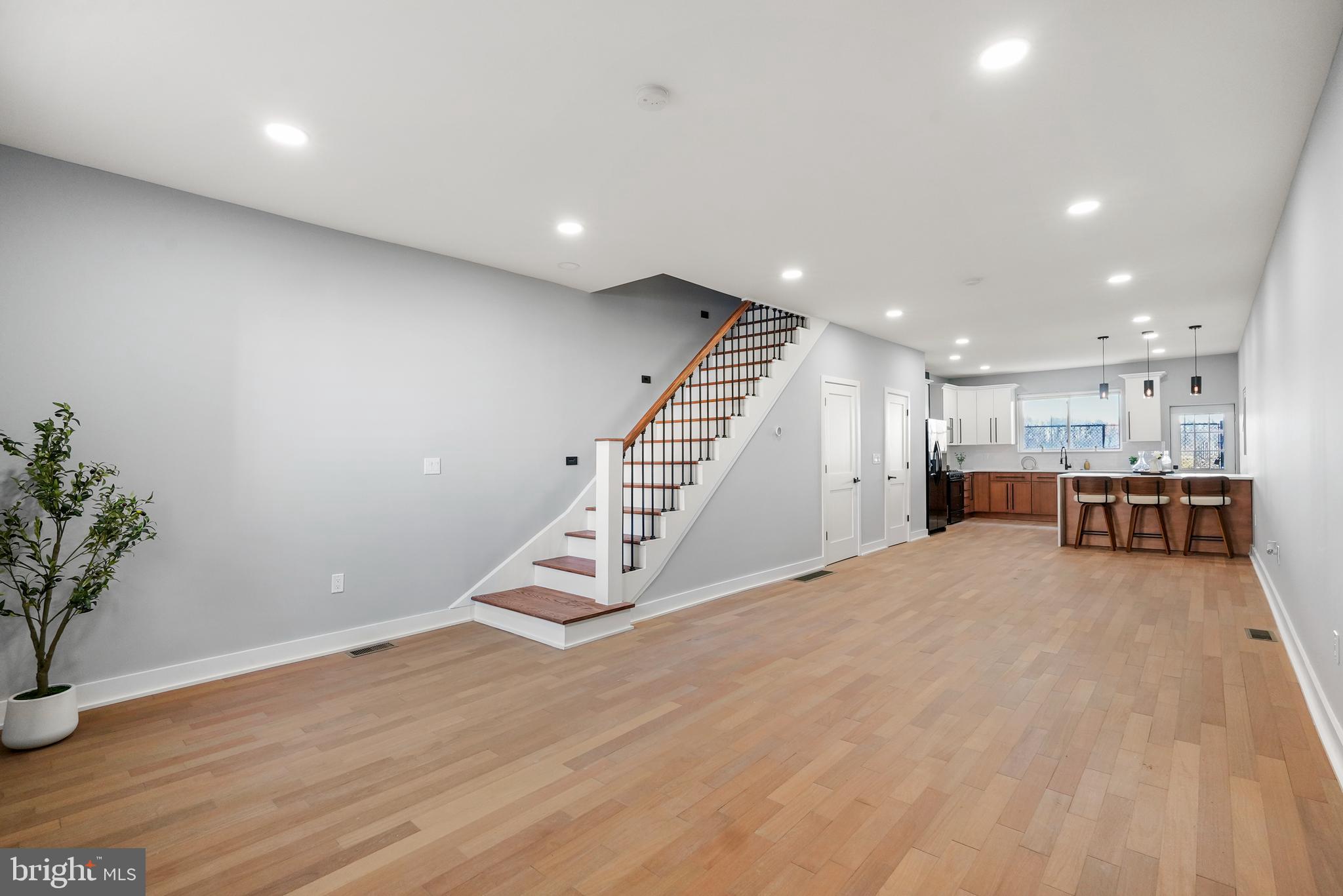2811 Salmon Street Philadelphia, PA 19134 - Photo 2 of 25 a view of an empty room with wooden floor and stairs