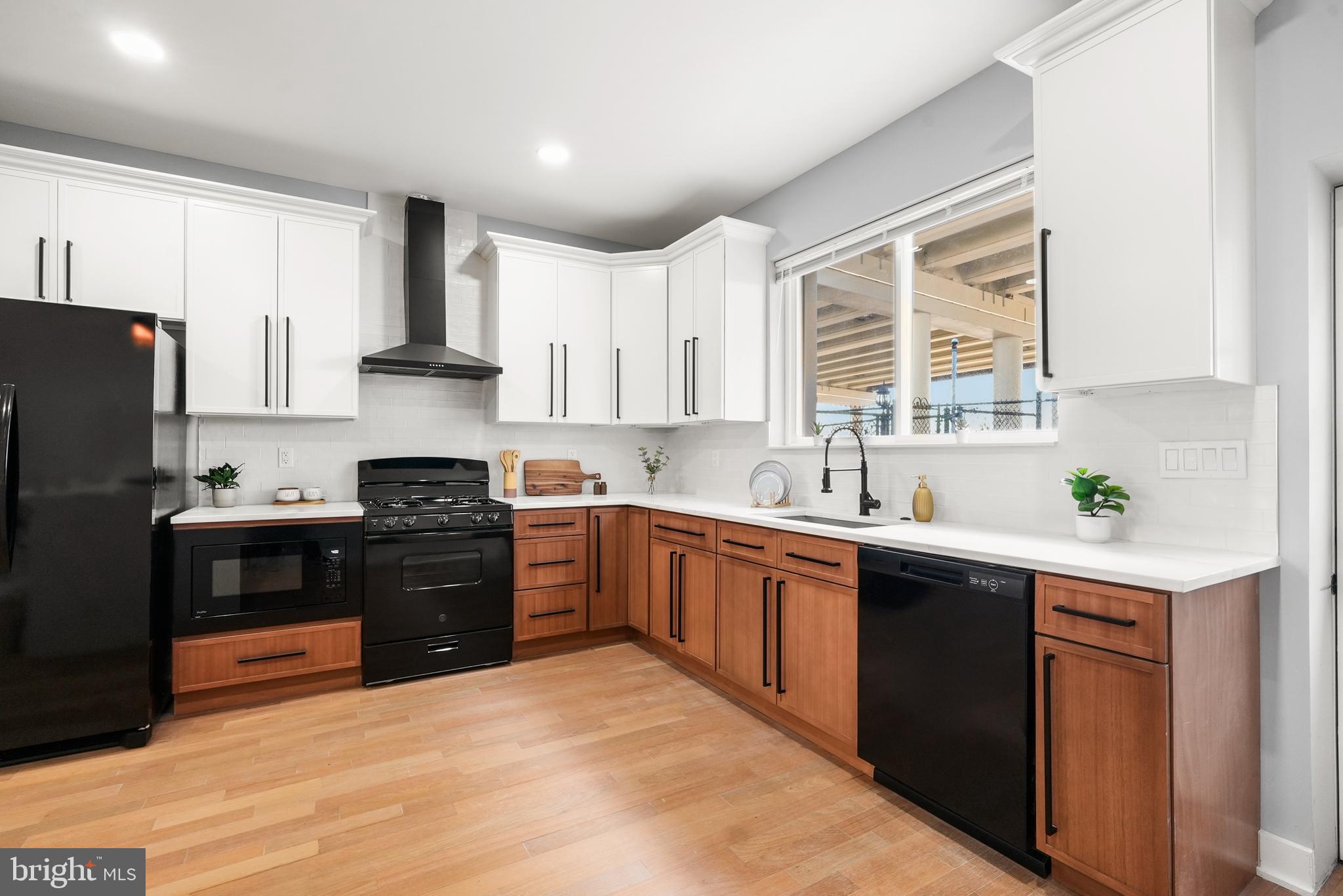 2811 Salmon Street Philadelphia, PA 19134 - Photo 4 of 25 a kitchen with a sink stove and refrigerator