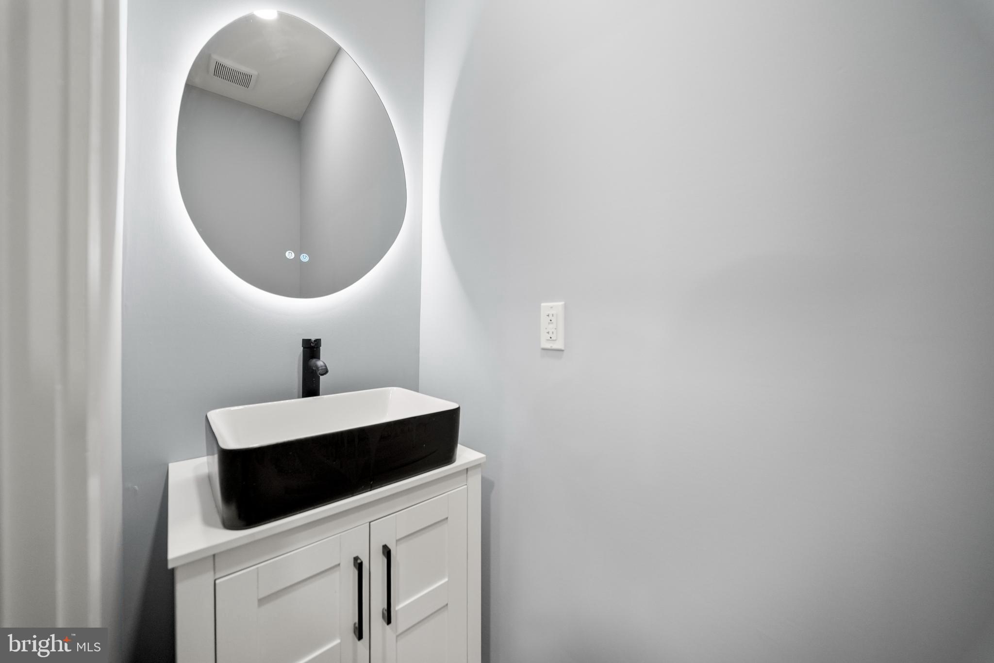 2811 Salmon Street Philadelphia, PA 19134 - Photo 7 of 25 a bathroom with a sink and a mirror