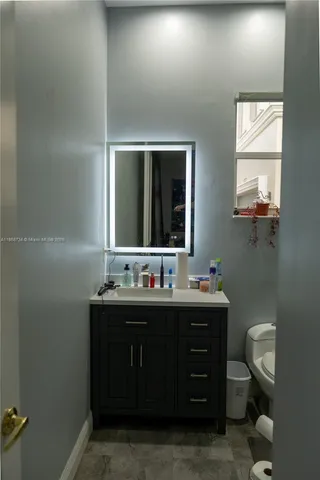 a bathroom with a shower a toilet and a sink