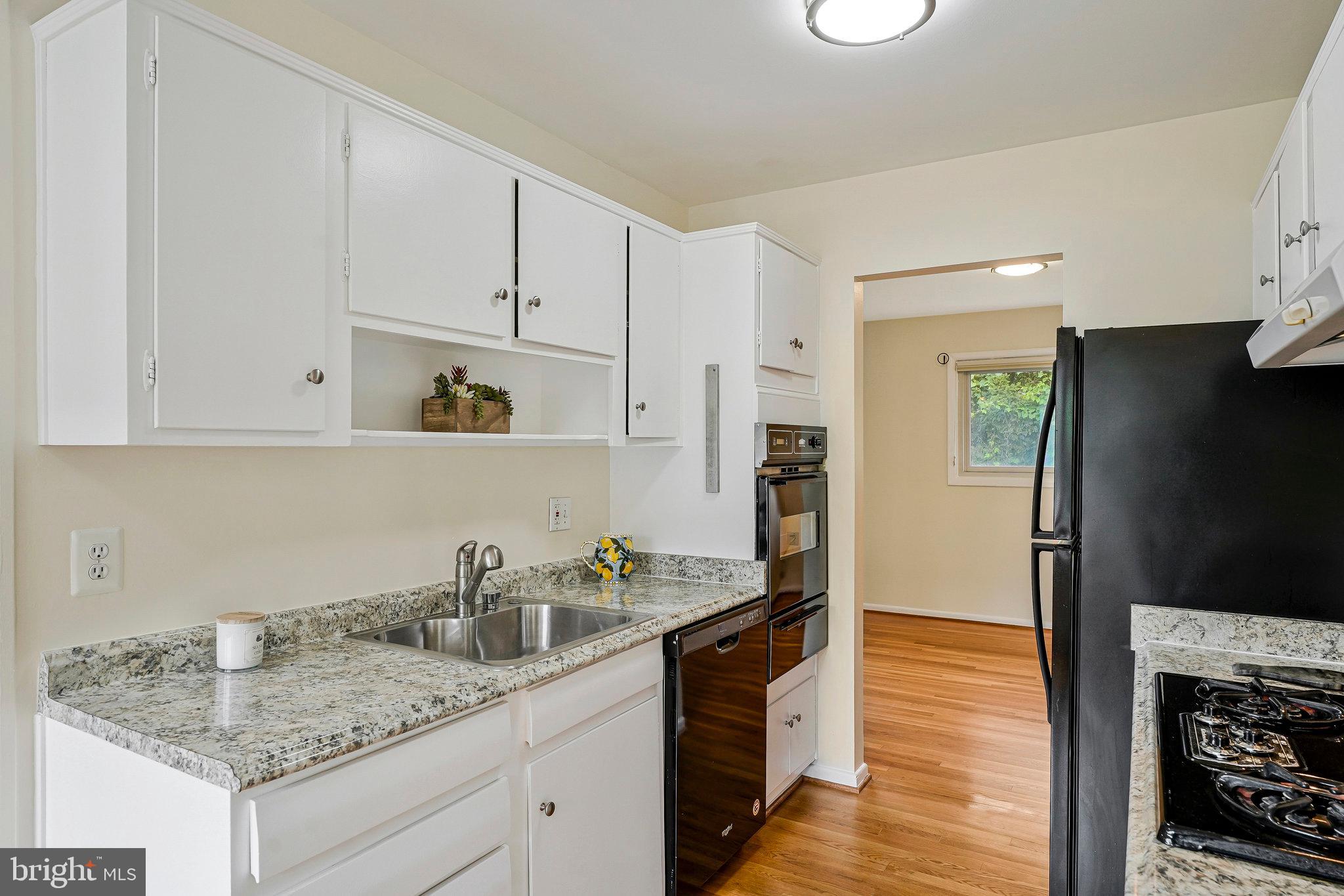 8230 Citadel Place Vienna, VA 22180 - Photo 11 of 38 a kitchen with white cabinets and refrigerator