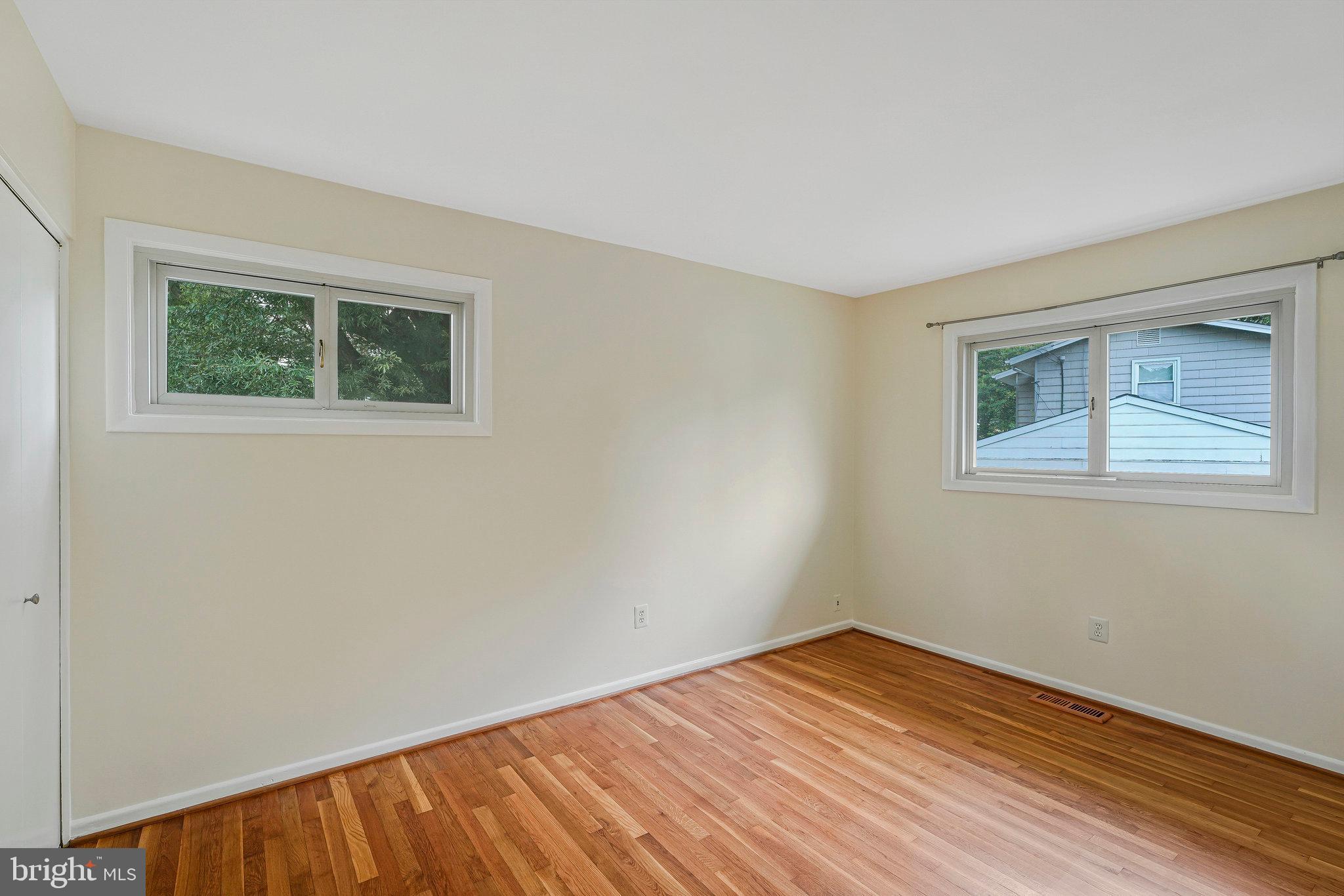 8230 Citadel Place Vienna, VA 22180 - Photo 14 of 38 a view of an empty room with wooden floor and a window