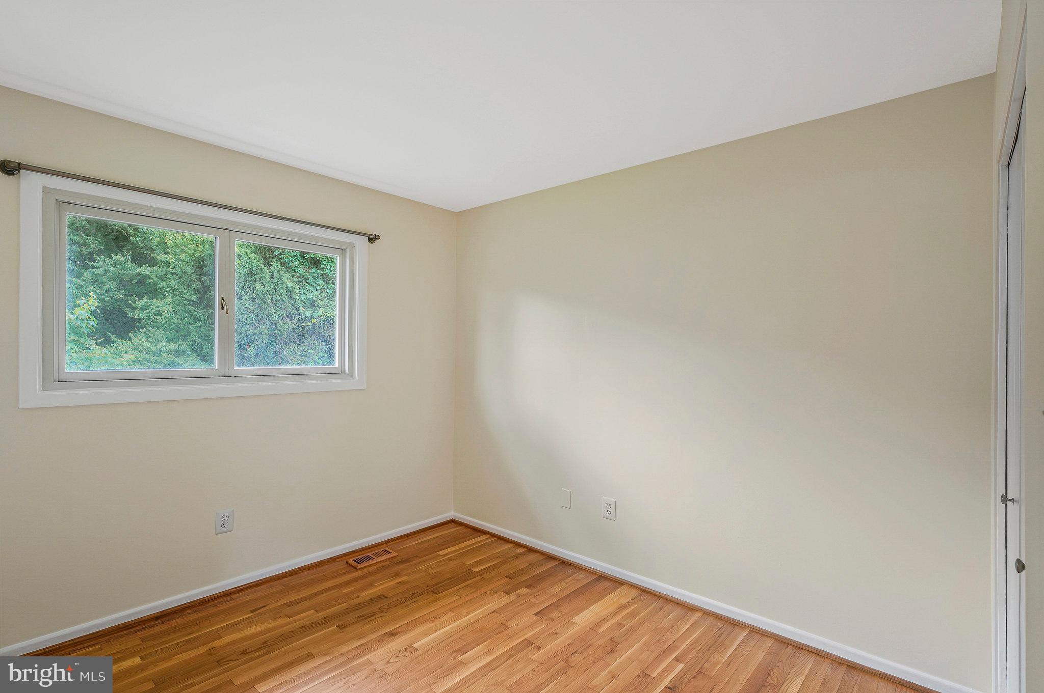 8230 Citadel Place Vienna, VA 22180 - Photo 17 of 38 a view of an empty room with wooden floor and a window