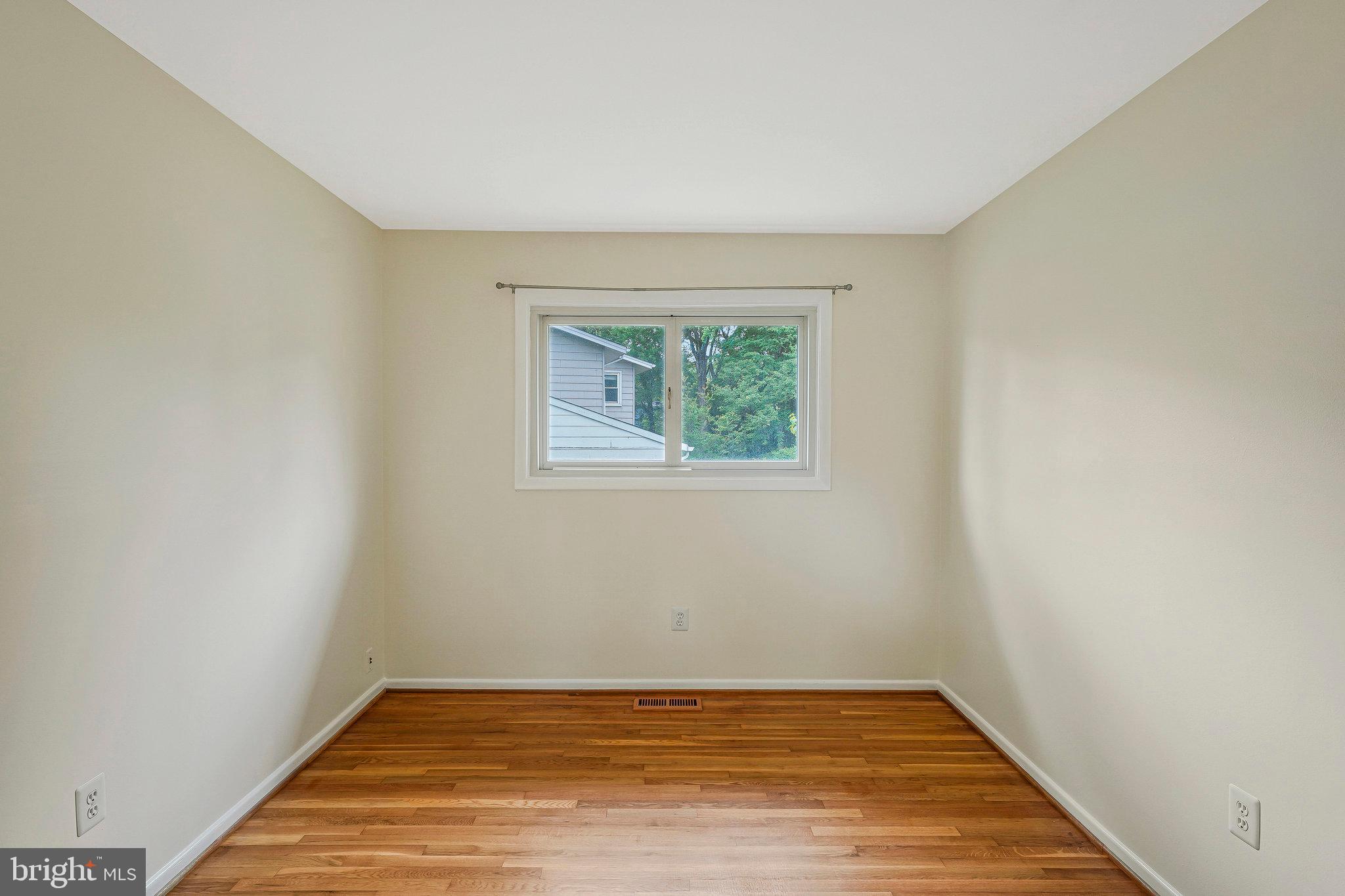 8230 Citadel Place Vienna, VA 22180 - Photo 18 of 38 a view of an empty room with wooden floor and a window