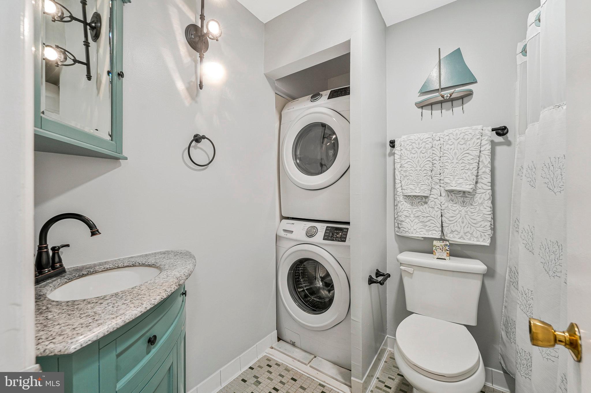 8230 Citadel Place Vienna, VA 22180 - Photo 19 of 38 a bathroom with a granite countertop toilet sink and mirror