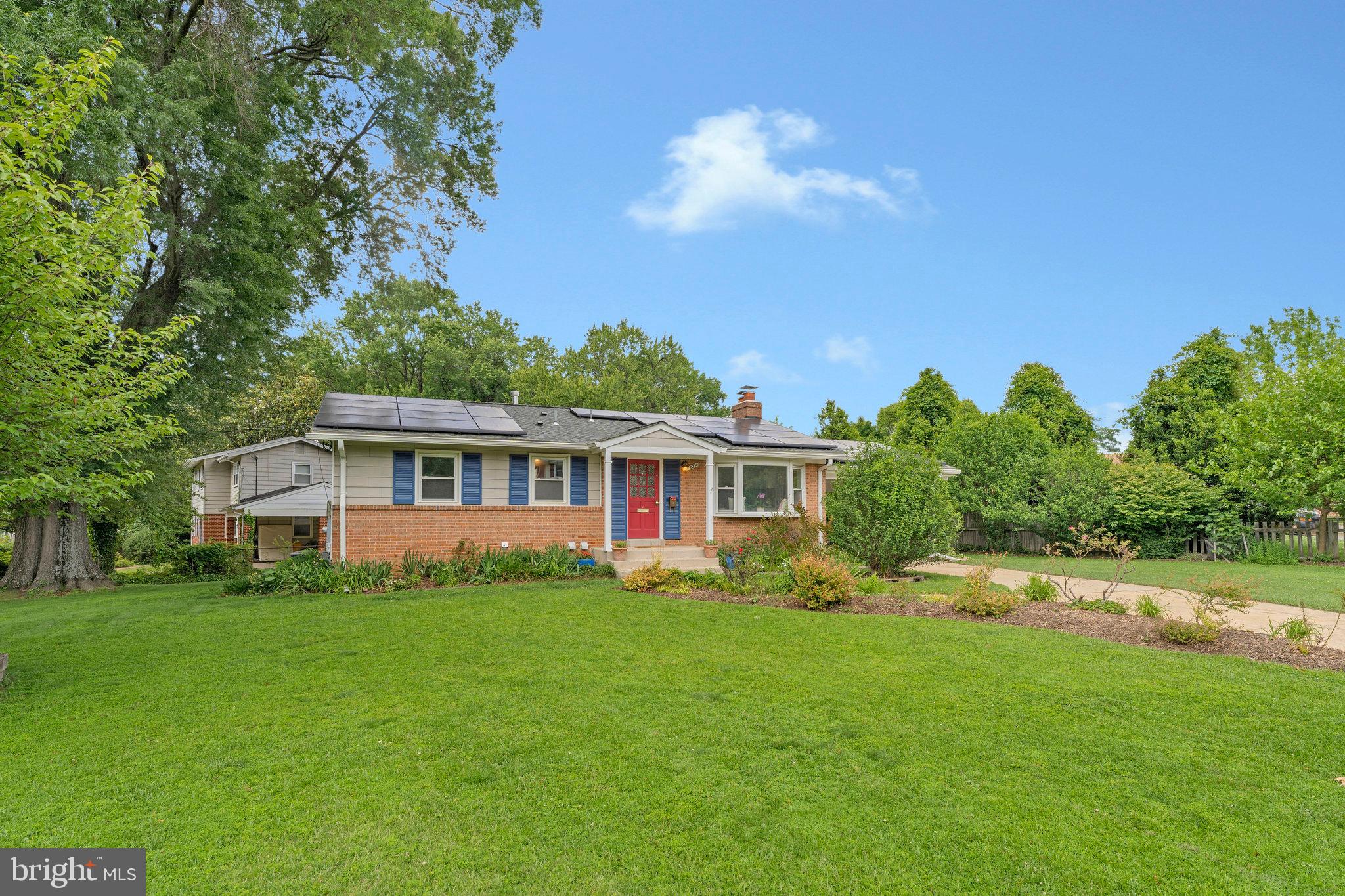 8230 Citadel Place Vienna, VA 22180 - Photo 2 of 38 a front view of a house with a garden