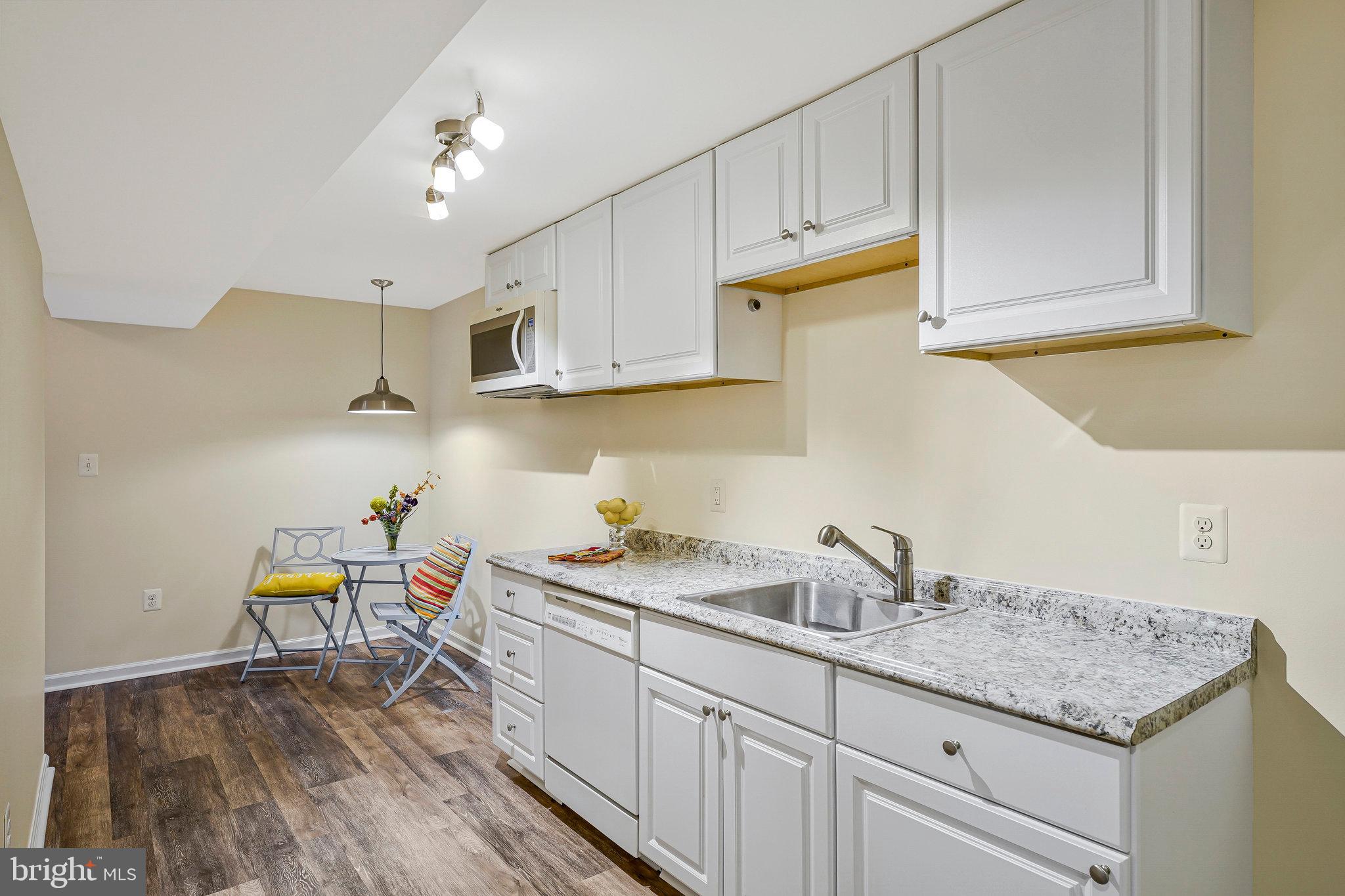 8230 Citadel Place Vienna, VA 22180 - Photo 22 of 38 a kitchen with granite countertop a sink a stove and cabinets