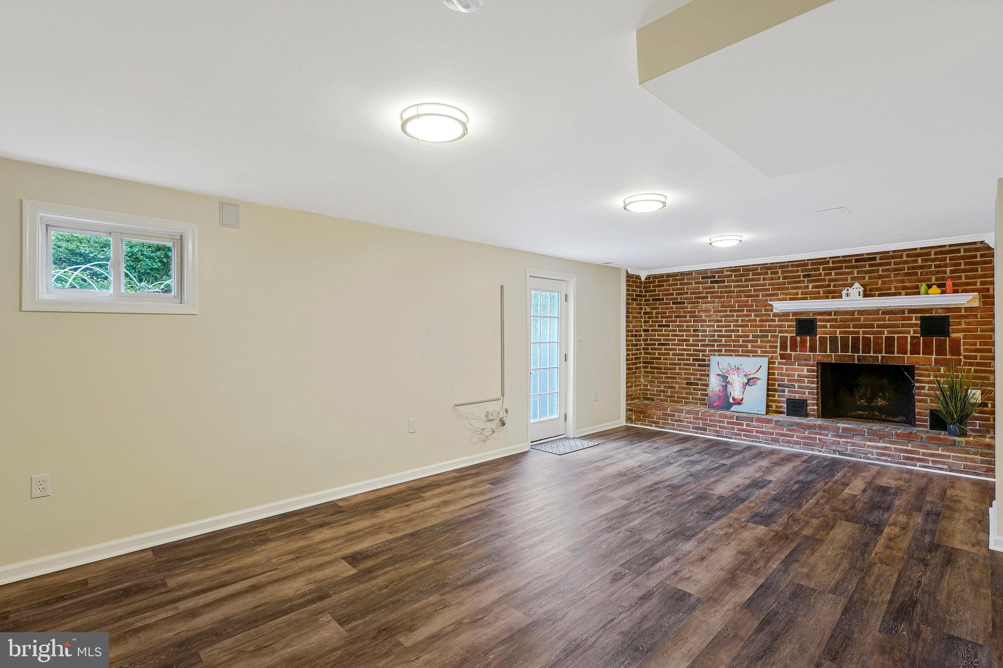 8230 Citadel Place Vienna, VA 22180 - Photo 30 of 38 wooden floor fireplace and natural light in room