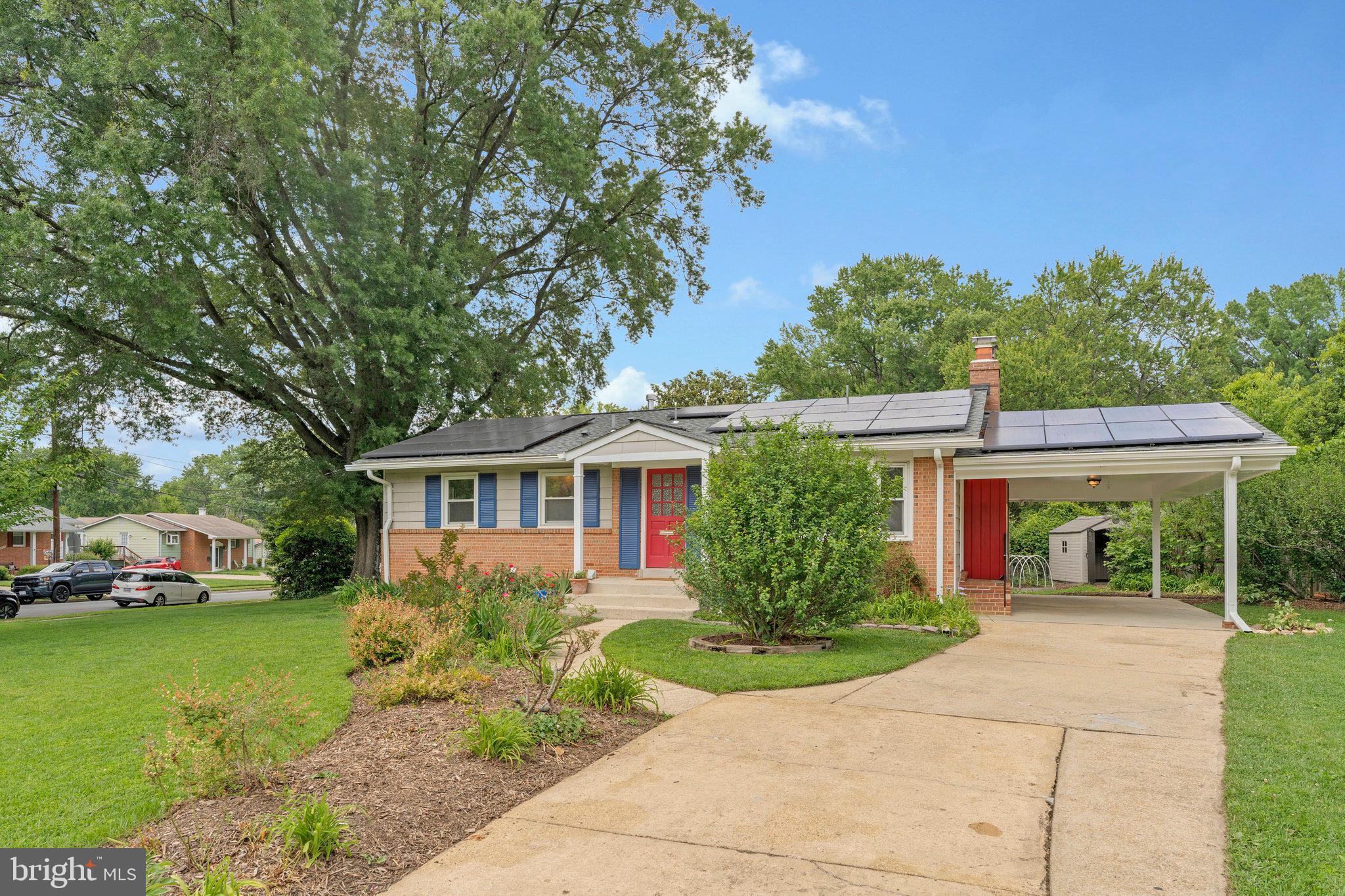 8230 Citadel Place Vienna, VA 22180 - Photo 3 of 38 a front view of a house with a yard and trees