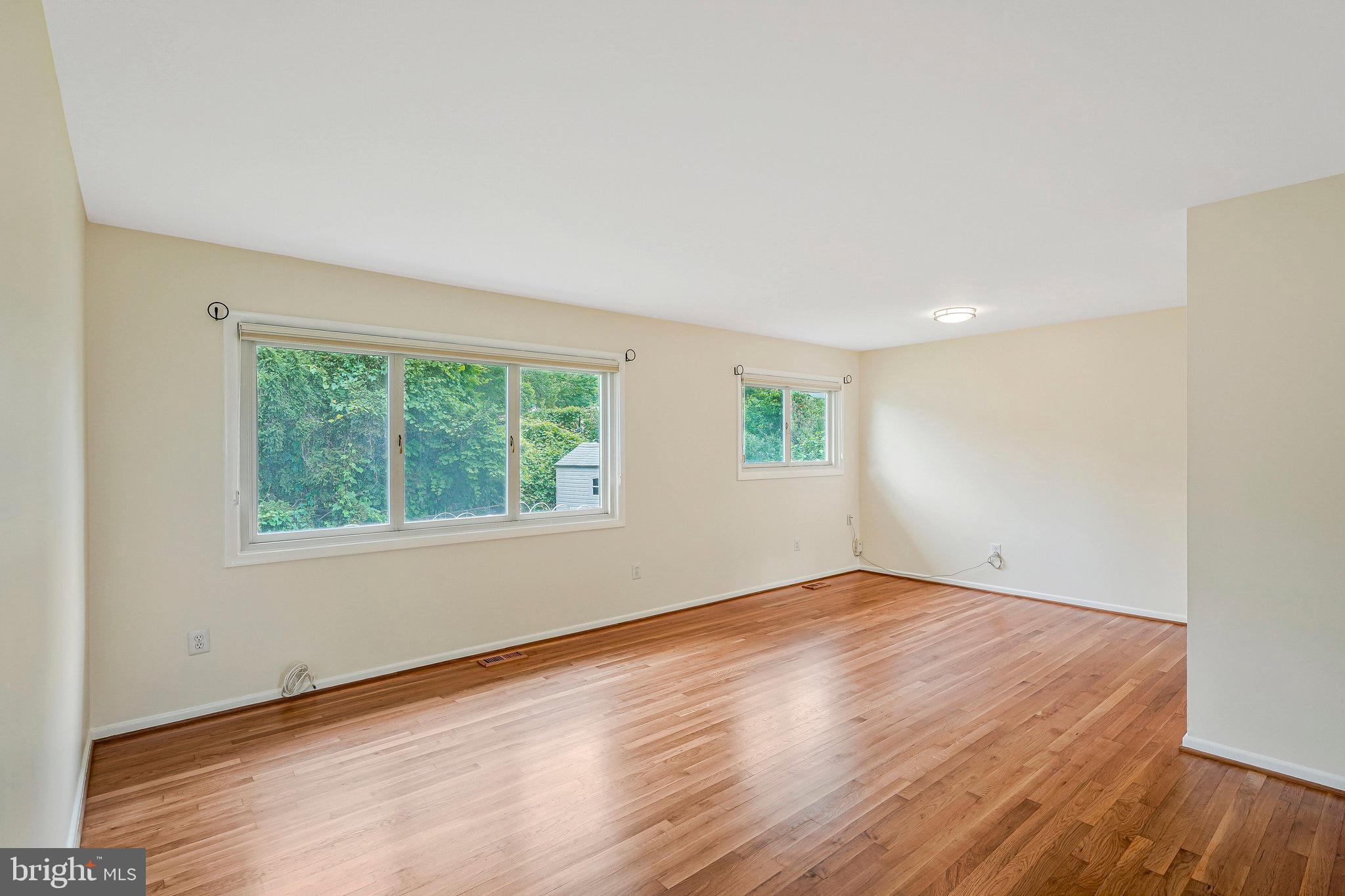 8230 Citadel Place Vienna, VA 22180 - Photo 6 of 38 an empty room with wooden floor and windows