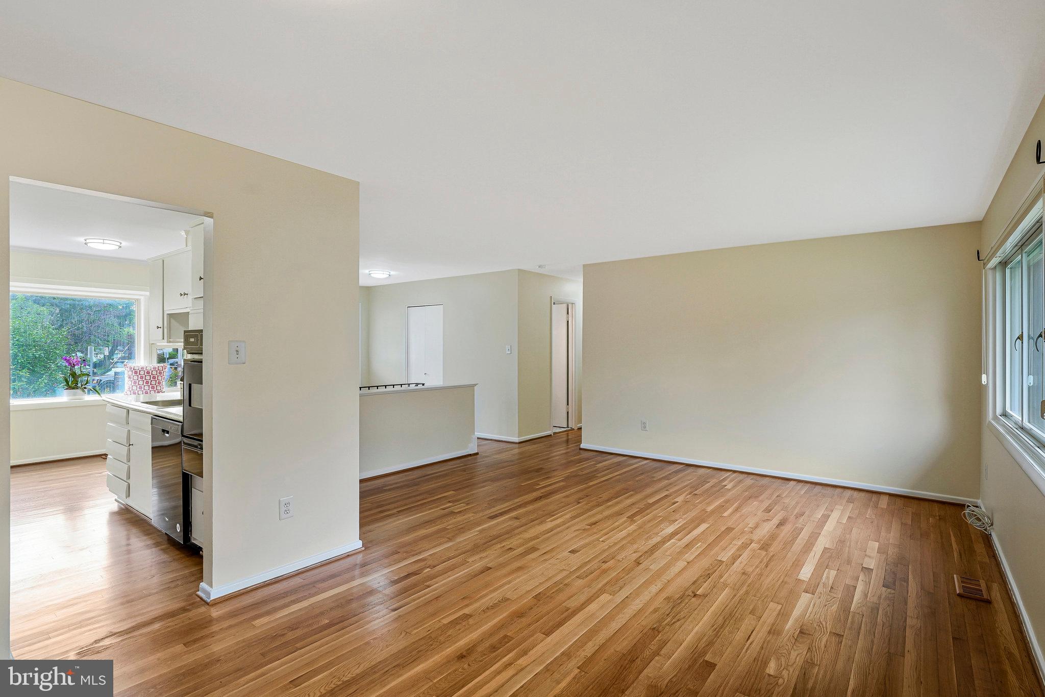 8230 Citadel Place Vienna, VA 22180 - Photo 8 of 38 a view of an empty room with wooden floor and a window