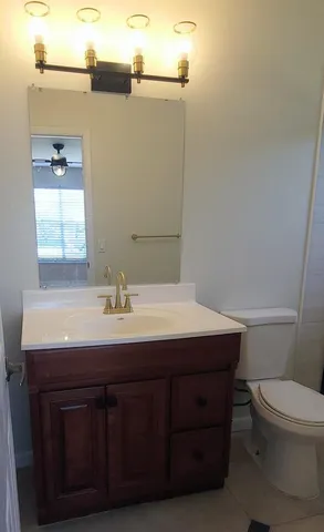 a bathroom with a sink a toilet and mirror