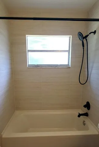a bathroom with a bath tub and a shower