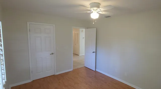 a view of an empty room with a fan