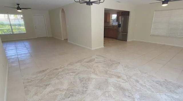 an empty room with windows and entrance