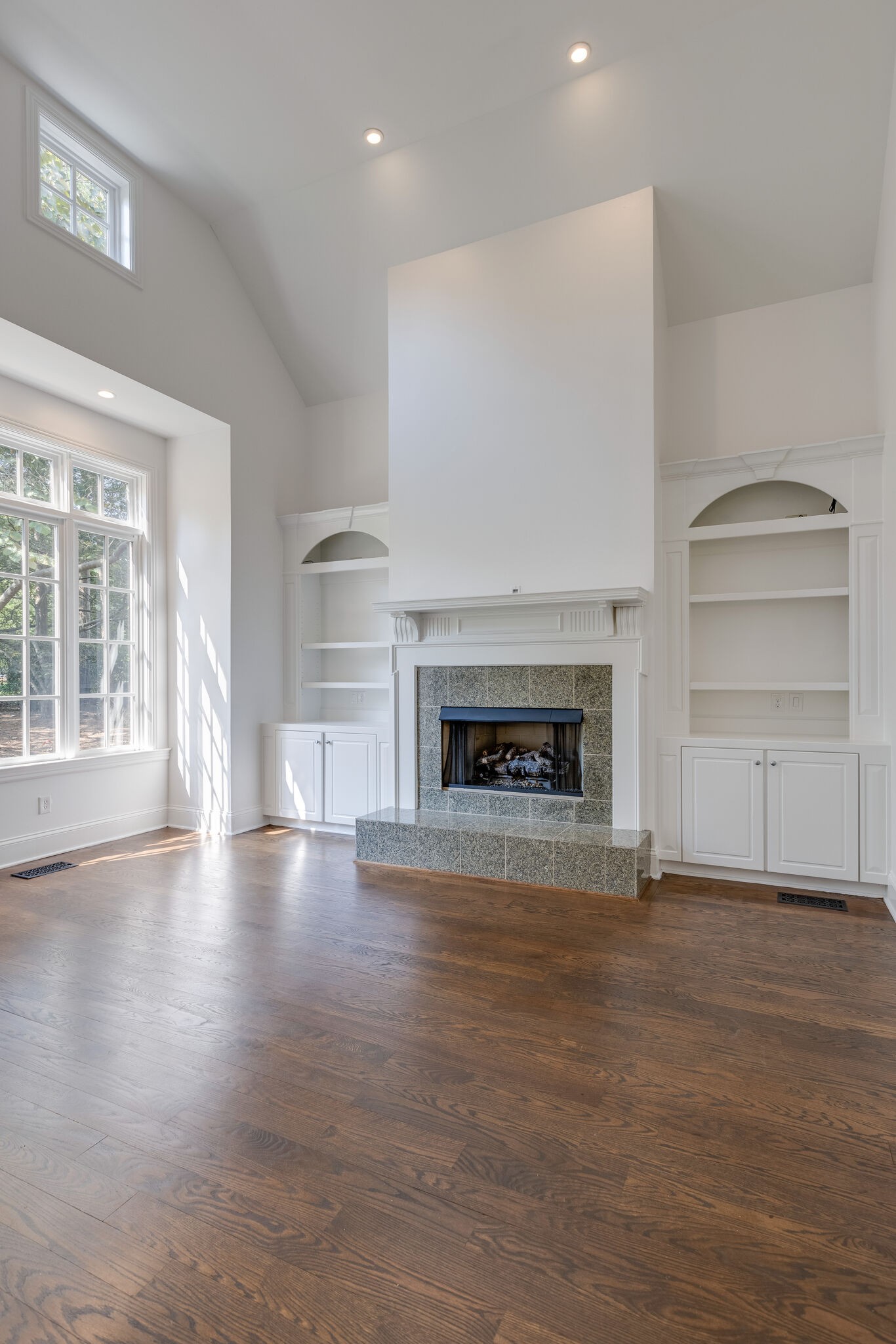 1438 Willowbrooke Circle Franklin, TN 37069 - Photo 11 of 45 an empty room with wooden floor fireplace and windows