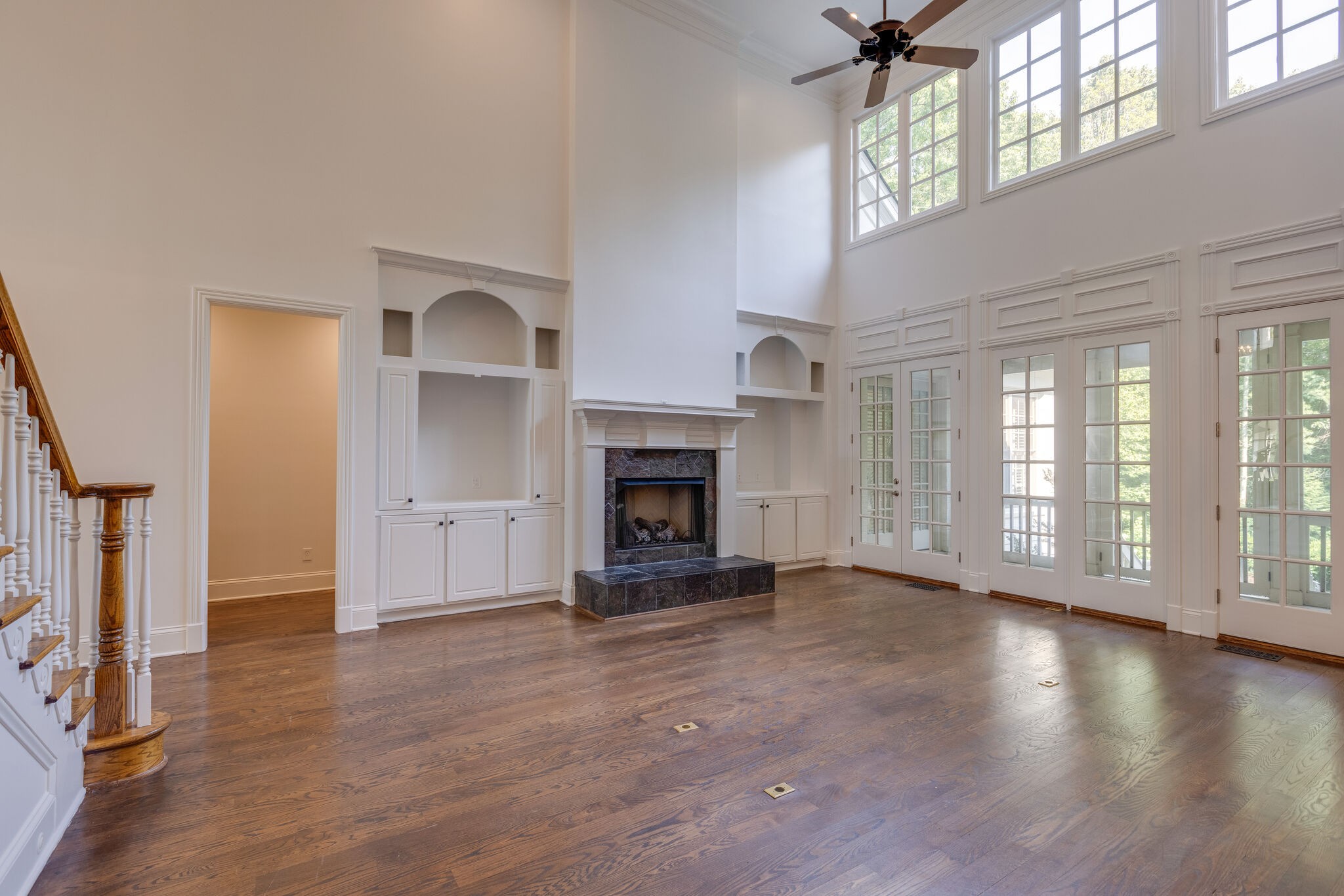 1438 Willowbrooke Circle Franklin, TN 37069 - Photo 14 of 45 a view of an empty room with wooden floor fireplace and a window