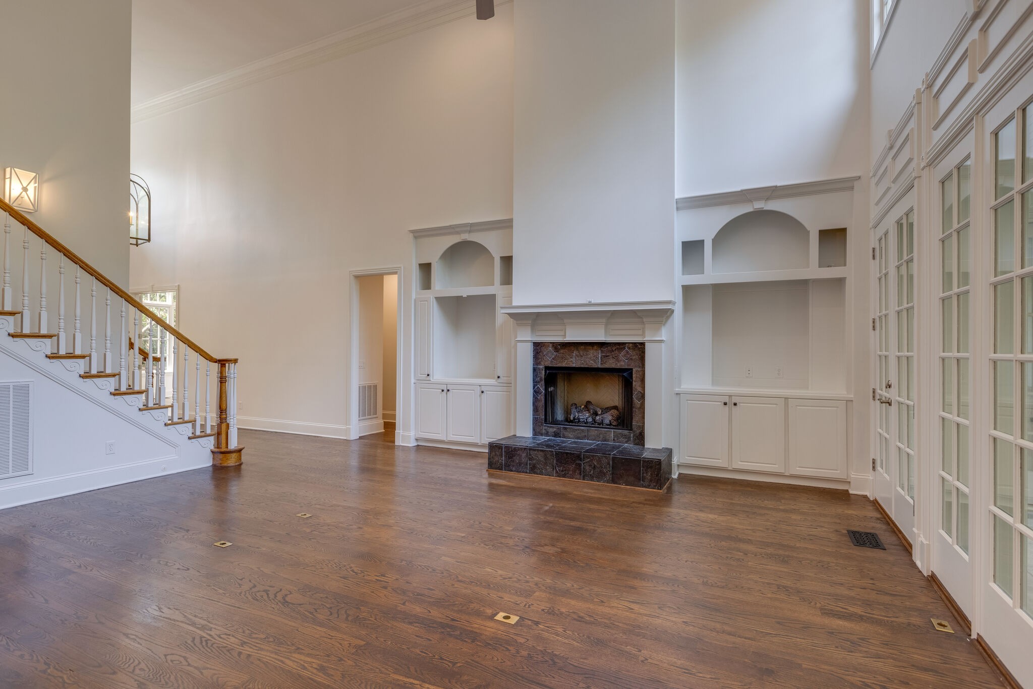 1438 Willowbrooke Circle Franklin, TN 37069 - Photo 15 of 45 a view of an empty room with wooden floor fireplace and a window