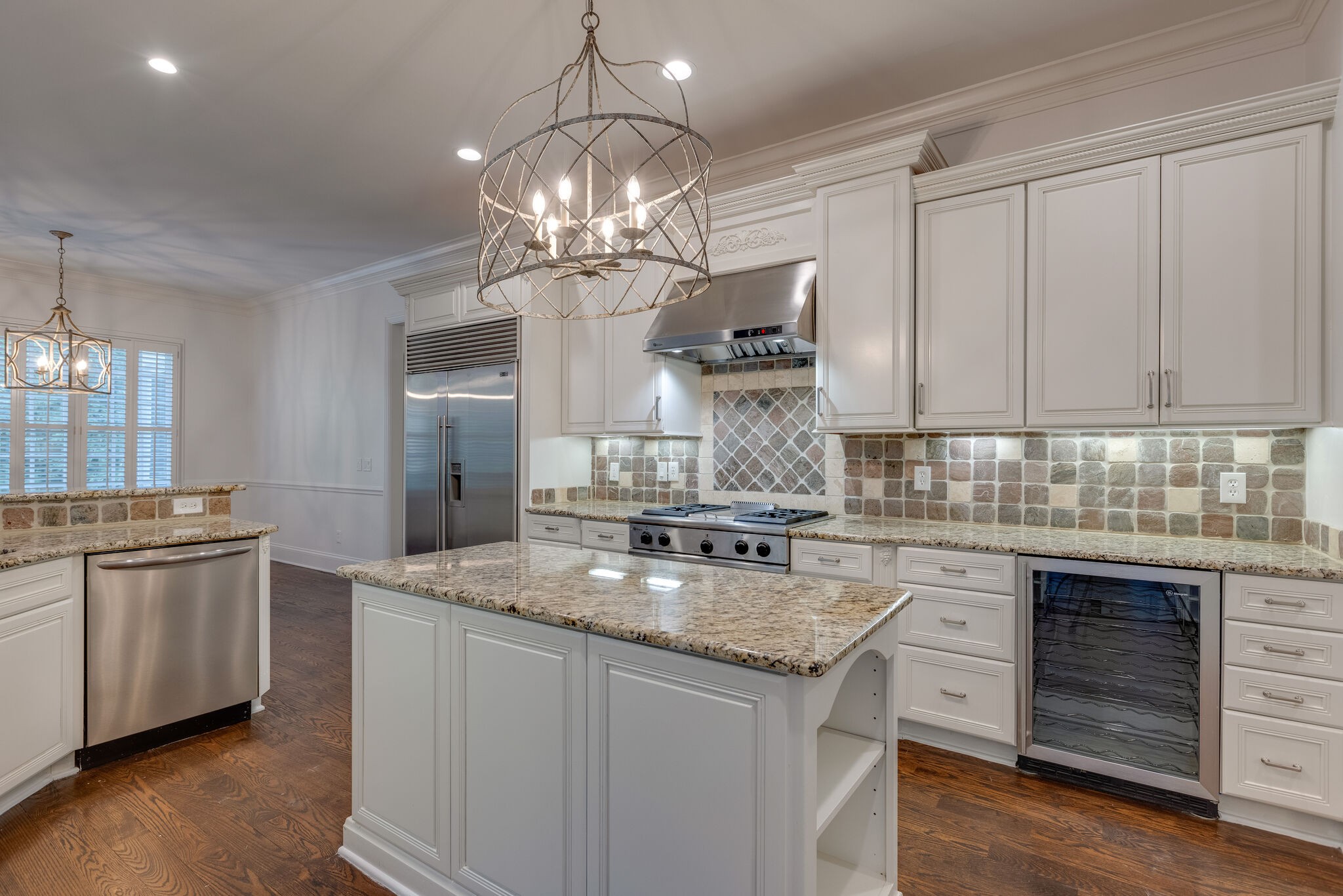 1438 Willowbrooke Circle Franklin, TN 37069 - Photo 22 of 45 a kitchen with kitchen island granite countertop stainless steel appliances a stove sink and cabinets