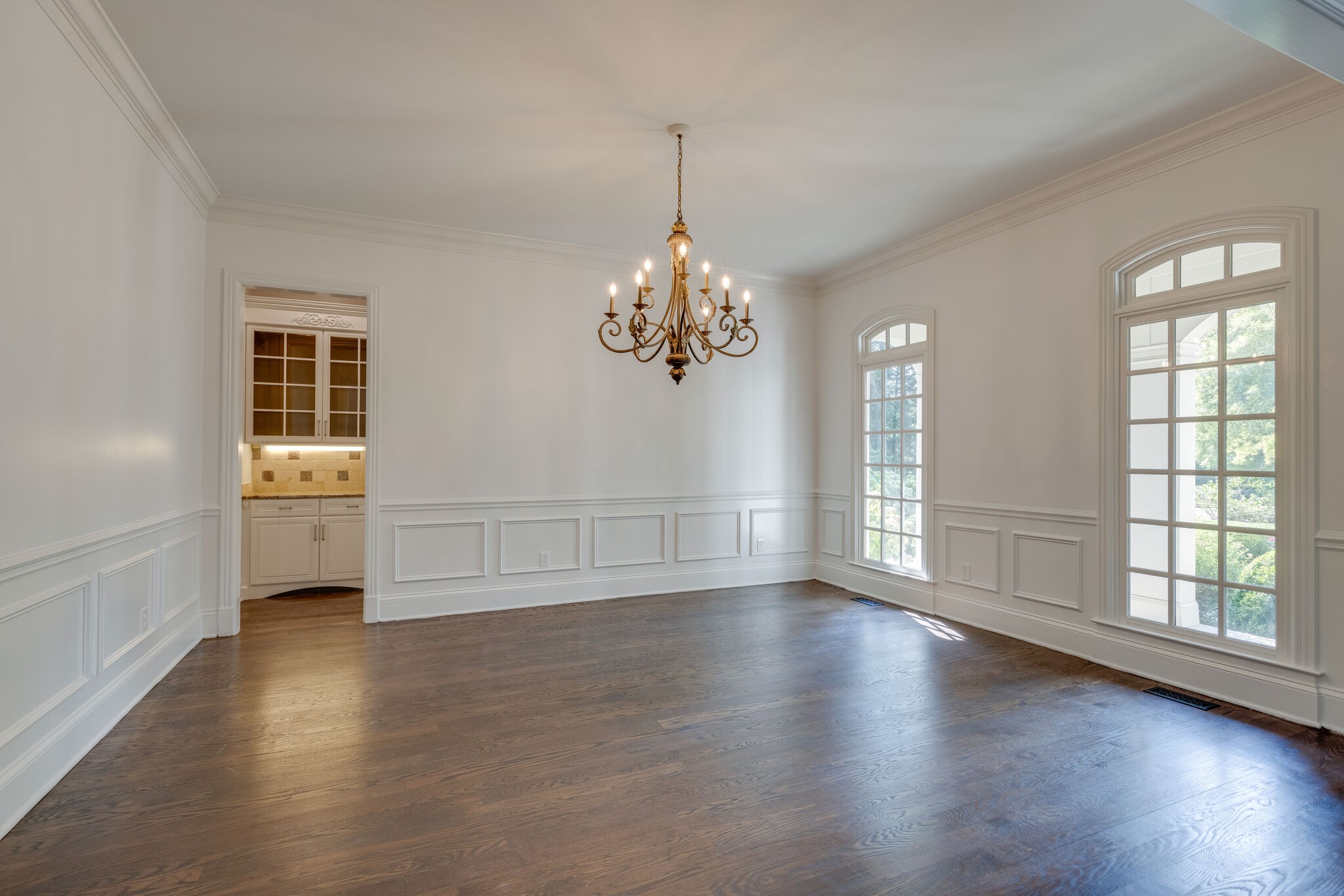 1438 Willowbrooke Circle Franklin, TN 37069 - Photo 8 of 45 an empty room with wooden floor chandelier and windows