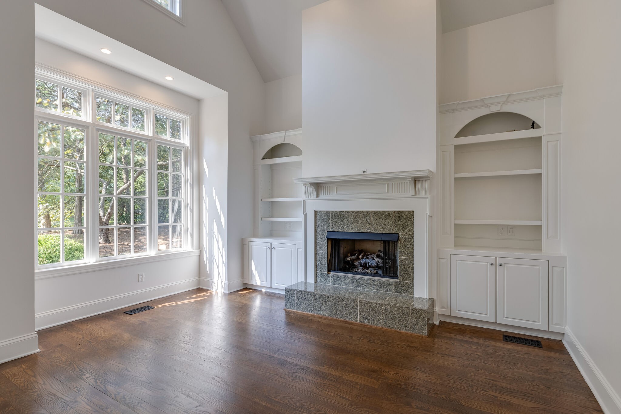 1438 Willowbrooke Circle Franklin, TN 37069 - Photo 10 of 45 a view of an empty room with wooden floor fireplace and a window