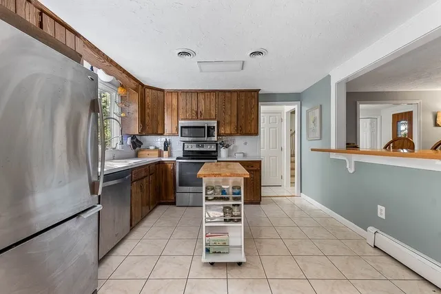 a kitchen with a refrigerator a stove a sink dishwasher and microwave