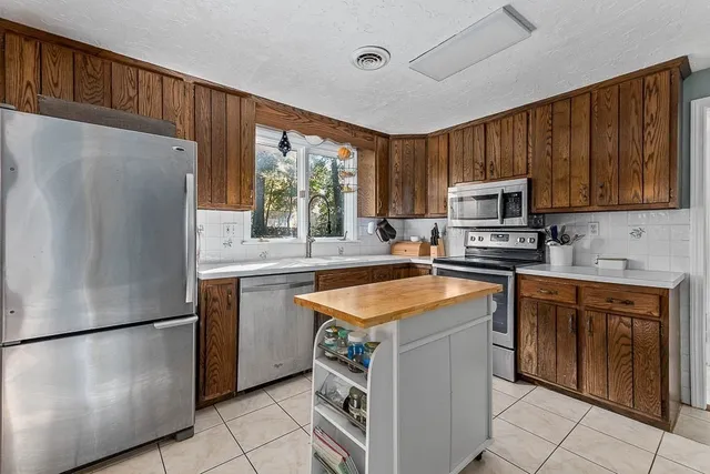 a kitchen with a stove and cabinets