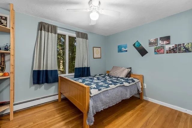 a view of room with wooden floor and cabinet