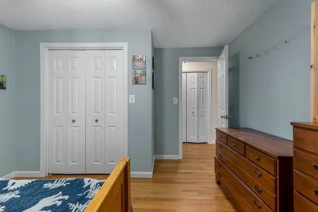 a bedroom with furniture and wooden floor
