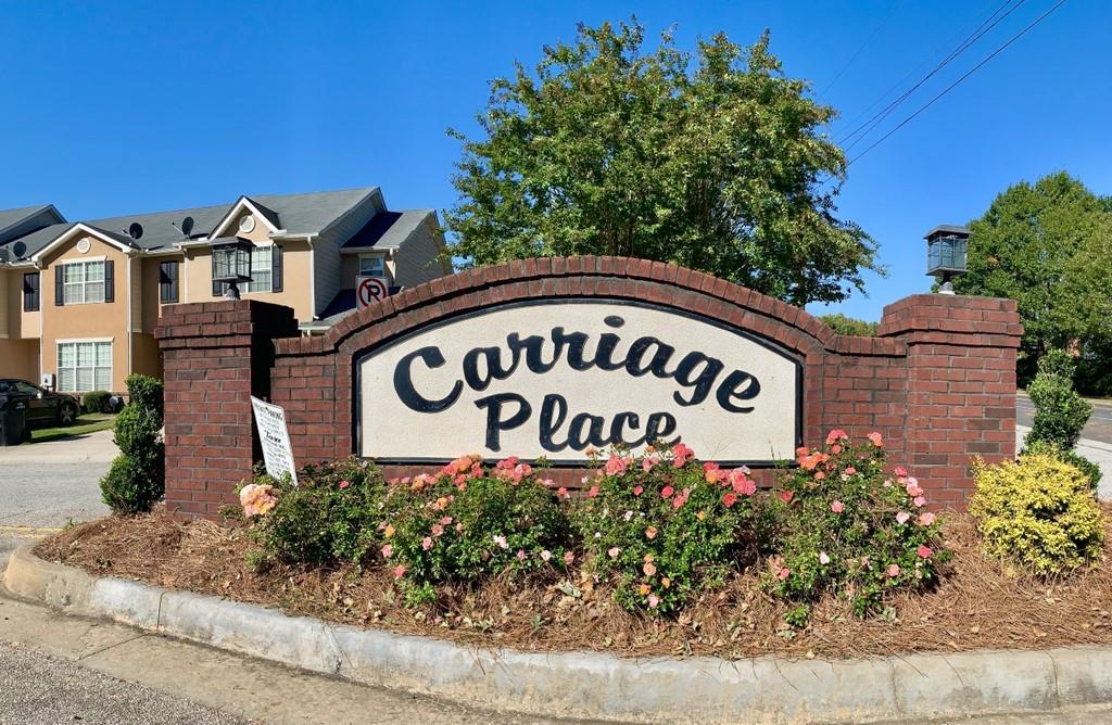 a sign broad in front of the red brick house